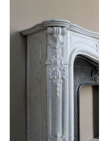 Louis XV “Moustache” fire surround in “Pure White" Carrara marble, complete with cast iron insert featuring floral decorations.