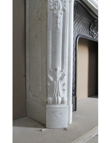 Louis XV “Moustache” fire surround in “Pure White" Carrara marble, complete with cast iron insert featuring floral decorations.