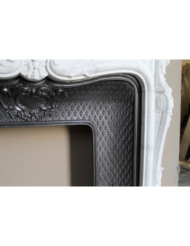 Louis XV “Moustache” fire surround in “Pure White" Carrara marble, complete with cast iron insert featuring floral decorations.