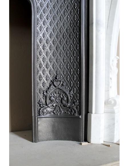 Louis XV “Moustache” fire surround in “Pure White" Carrara marble, complete with cast iron insert featuring floral decorations.