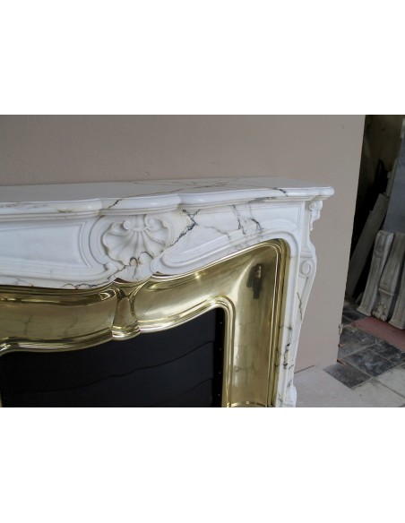 Exceptional Louis XV "Trois Coquilles" fireplace mantel in rare white veined Paonazzetto marble with original gilt brass insert.