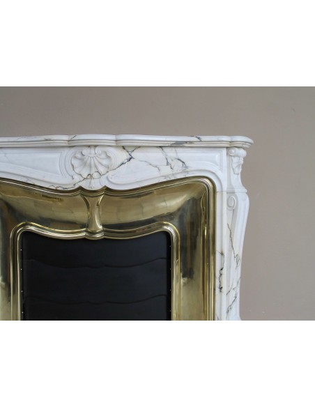 Exceptional Louis XV "Trois Coquilles" fireplace mantel in rare white veined Paonazzetto marble with original gilt brass insert.