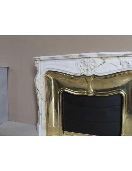 Exceptional Louis XV "Trois Coquilles" fireplace mantel in rare white veined Paonazzetto marble with original gilt brass insert.