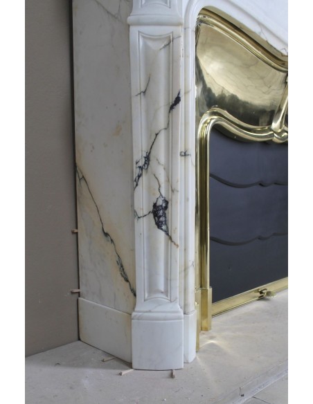 Exceptional Louis XV "Trois Coquilles" fireplace mantel in rare white veined Paonazzetto marble with original gilt brass insert.