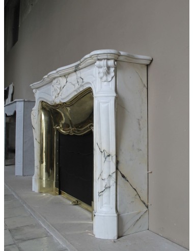 Exceptional Louis XV "Trois Coquilles" fireplace mantel in rare white veined Paonazzetto marble with original gilt brass insert.