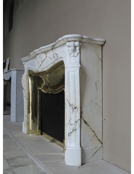 Exceptional Louis XV "Trois Coquilles" fireplace mantel in rare white veined Paonazzetto marble with original gilt brass insert.