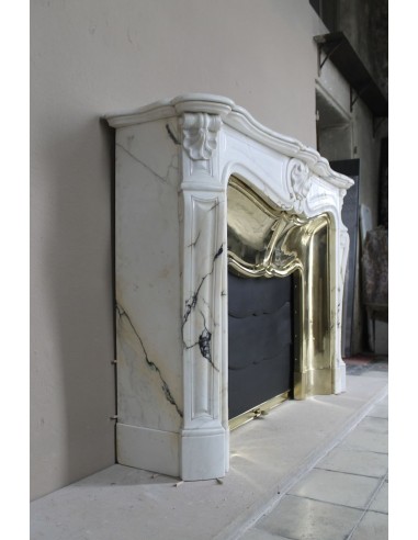 Exceptional Louis XV "Trois Coquilles" fireplace mantel in rare white veined Paonazzetto marble with original gilt brass insert.