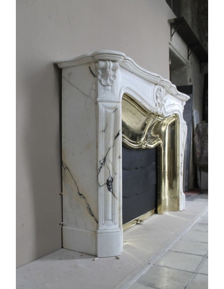 Exceptional Louis XV "Trois Coquilles" fireplace mantel in rare white veined Paonazzetto marble with original gilt brass insert.