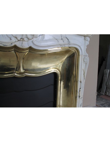 Exceptional Louis XV "Trois Coquilles" fireplace mantel in rare white veined Paonazzetto marble with original gilt brass insert.