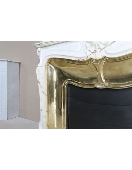 Exceptional Louis XV "Trois Coquilles" fireplace mantel in rare white veined Paonazzetto marble with original gilt brass insert.