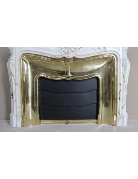 Exceptional Louis XV "Trois Coquilles" fireplace mantel in rare white veined Paonazzetto marble with original gilt brass insert.