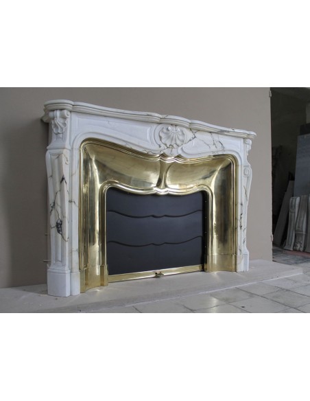 Exceptional Louis XV "Trois Coquilles" fireplace mantel in rare white veined Paonazzetto marble with original gilt brass insert.