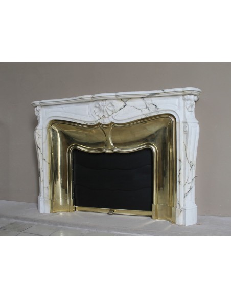 Exceptional Louis XV "Trois Coquilles" fireplace mantel in rare white veined Paonazzetto marble with original gilt brass insert.