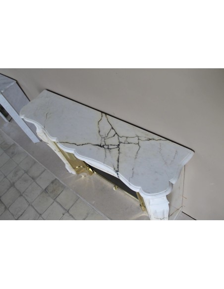 Exceptional Louis XV "Trois Coquilles" fireplace mantel in rare white veined Paonazzetto marble with original gilt brass insert.