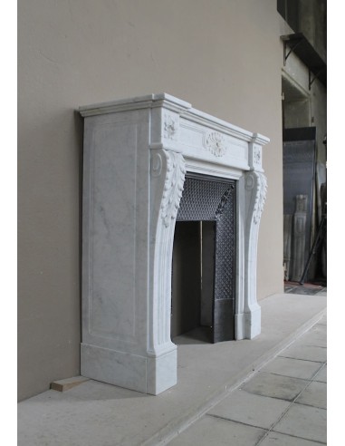 Neoclassical "Trois Fleurs" fireplace mantel in white marble with cast iron insert, small size and rich decorative detailing.