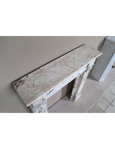 Small and lovely antique Neoclassical fireplace mantel in Calacatta Gold marble, with floral decorations and fluted detailing.