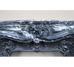 Antique Baroque-style fireplace mantel carved in black Marquinia marble with white veining, with its original cast iron insert. 2