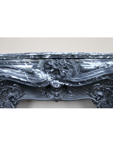 Antique Baroque-style fireplace mantel carved in black Marquinia marble with white veining, with its original cast iron insert.