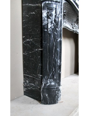 Antique Baroque-style fireplace mantel carved in black Marquinia marble with white veining, with its original cast iron insert.