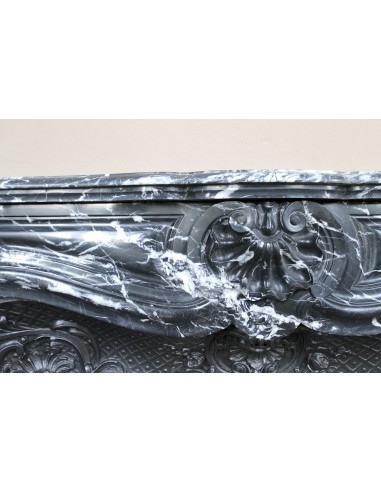 Antique Baroque-style fireplace mantel carved in black Marquinia marble with white veining, with its original cast iron insert.