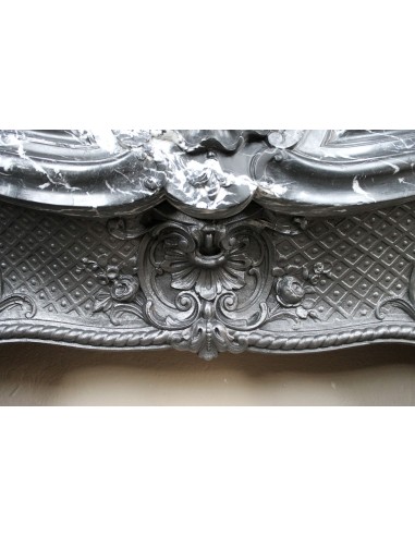 Antique Baroque-style fireplace mantel carved in black Marquinia marble with white veining, with its original cast iron insert.