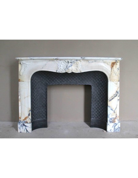 Genuine Baroque fireplace mantel in Calacatta Gold marble with shell carvings, with its original “Tapisserie” cast iron insert.