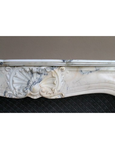 Genuine Baroque fireplace mantel in Calacatta Gold marble with shell carvings, with its original “Tapisserie” cast iron insert.