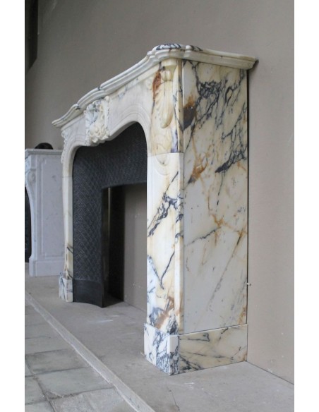 Genuine Baroque fireplace mantel in Calacatta Gold marble with shell carvings, with its original “Tapisserie” cast iron insert.
