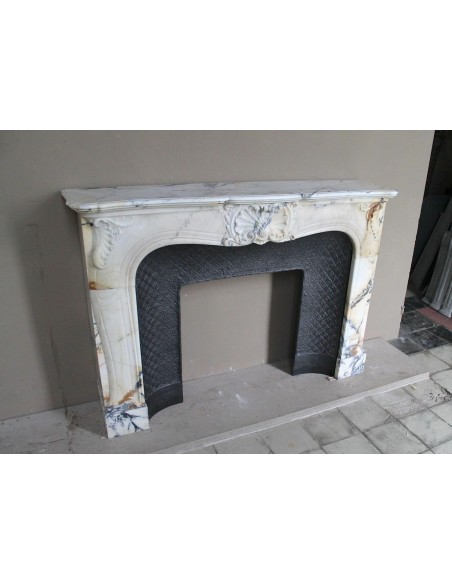 Genuine Baroque fireplace mantel in Calacatta Gold marble with shell carvings, with its original “Tapisserie” cast iron insert.