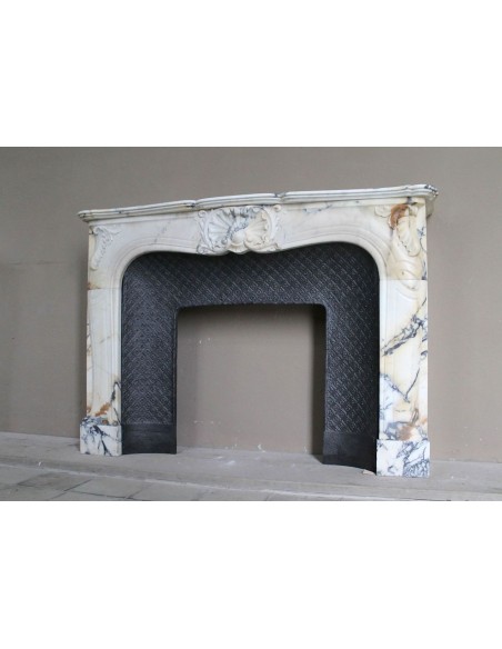 Genuine Baroque fireplace mantel in Calacatta Gold marble with shell carvings, with its original “Tapisserie” cast iron insert.