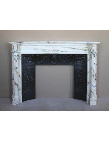 Rare and refined Neoclassical “Macaron” fireplace mantel with floral sculptural elements, perlage detailing, and column motifs.