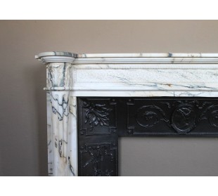 Rare and refined Neoclassical “Macaron” fireplace mantel with floral sculptural elements, perlage detailing, and column motifs. 2