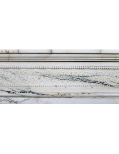 Rare and refined Neoclassical “Macaron” fireplace mantel with floral sculptural elements, perlage detailing, and column motifs.