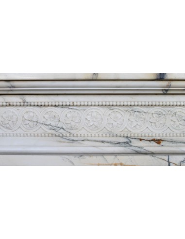 Rare and refined Neoclassical “Macaron” fireplace mantel with floral sculptural elements, perlage detailing, and column motifs.