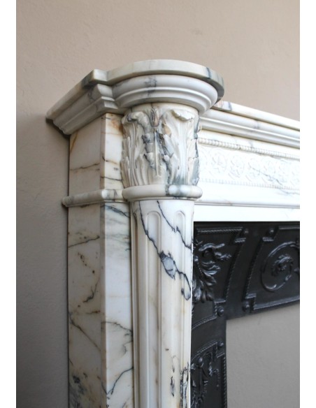 Rare and refined Neoclassical “Macaron” fireplace mantel with floral sculptural elements, perlage detailing, and column motifs.