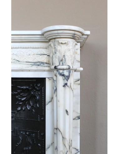 Rare and refined Neoclassical “Macaron” fireplace mantel with floral sculptural elements, perlage detailing, and column motifs.