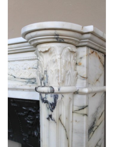 Rare and refined Neoclassical “Macaron” fireplace mantel with floral sculptural elements, perlage detailing, and column motifs.
