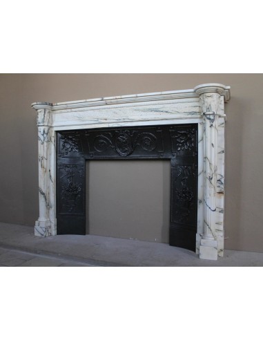 Rare and refined Neoclassical “Macaron” fireplace mantel with floral sculptural elements, perlage detailing, and column motifs.