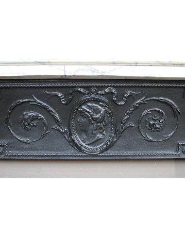 Rare and refined Neoclassical “Macaron” fireplace mantel with floral sculptural elements, perlage detailing, and column motifs.