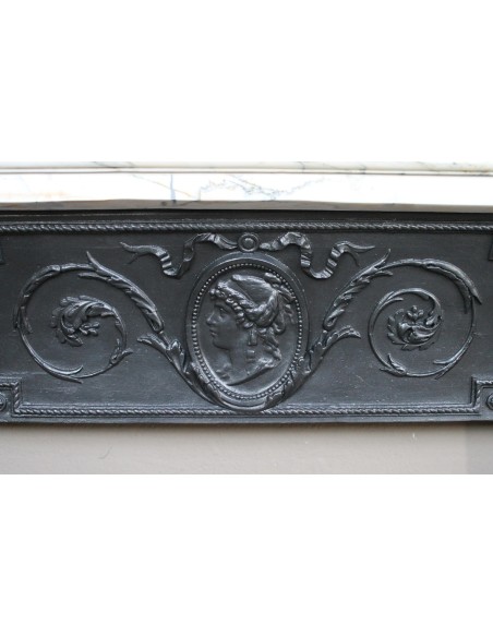 Rare and refined Neoclassical “Macaron” fireplace mantel with floral sculptural elements, perlage detailing, and column motifs.