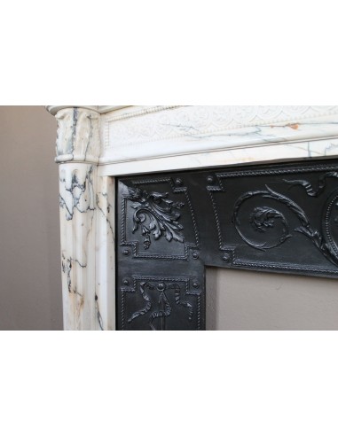 Rare and refined Neoclassical “Macaron” fireplace mantel with floral sculptural elements, perlage detailing, and column motifs.