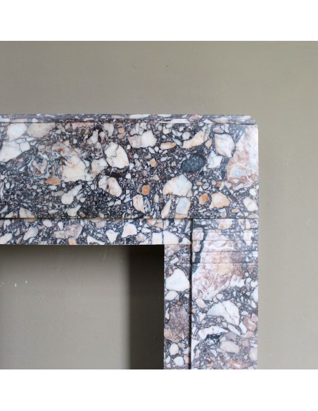 Antique Art Deco fireplace mantel in variegated Africano marble. This marble fireplace surround is genuine, hand-carved.