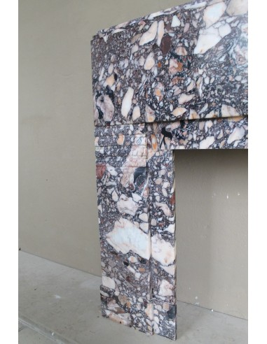 Antique Art Deco fireplace mantel in variegated Africano marble. This marble fireplace surround is genuine, hand-carved.