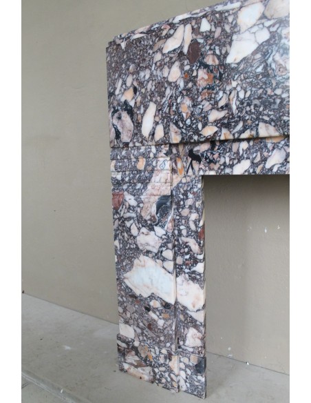 Antique Art Deco fireplace mantel in variegated Africano marble. This marble fireplace surround is genuine, hand-carved.