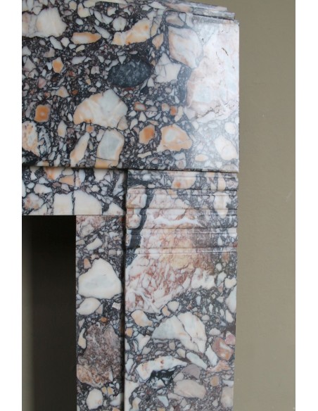 Antique Art Deco fireplace mantel in variegated Africano marble. This marble fireplace surround is genuine, hand-carved.