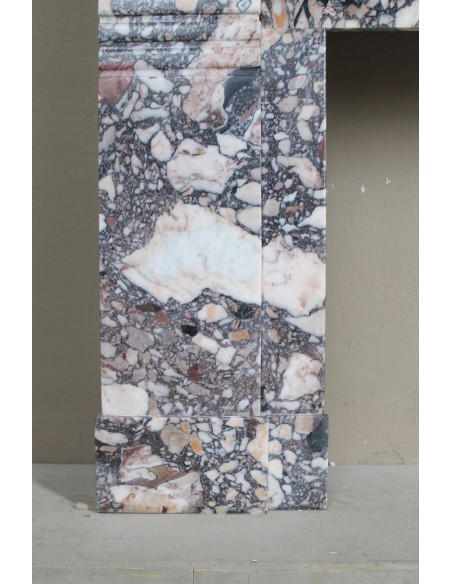 Antique Art Deco fireplace mantel in variegated Africano marble. This marble fireplace surround is genuine, hand-carved.