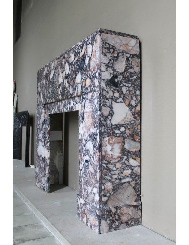 Antique Art Deco fireplace mantel in variegated Africano marble. This marble fireplace surround is genuine, hand-carved.