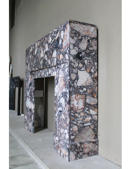 Antique Art Deco fireplace mantel in variegated Africano marble. This marble fireplace surround is genuine, hand-carved.