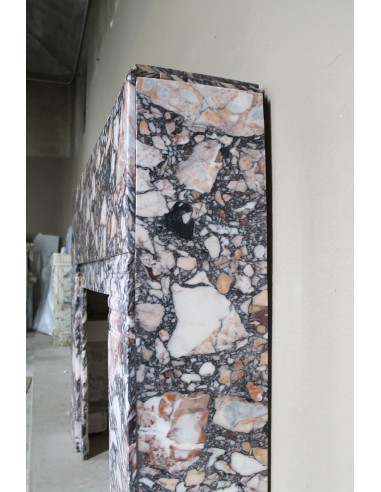 Antique Art Deco fireplace mantel in variegated Africano marble. This marble fireplace surround is genuine, hand-carved.