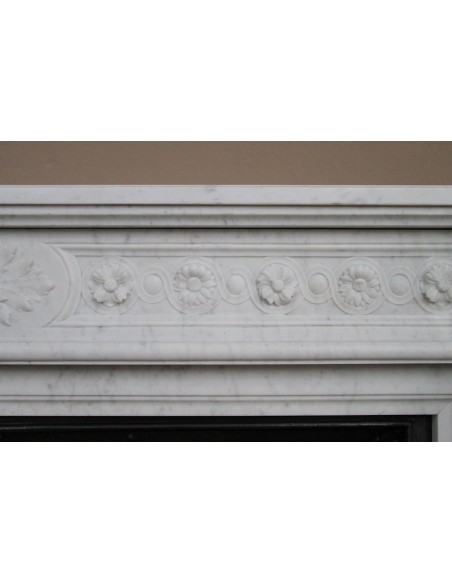 Antique Neoclassical “Macaron” fireplace mantel with exquisitely refined floral sculptural details, in white Carrara marble